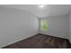 A bedroom with neutral walls, brown carpet, and a window at 420 Tavistock Ct, Mcdonough, GA 30252