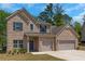 Attractive brick two-story home with a two-car garage and a well-maintained lawn, nestled in a serene setting at 420 Tavistock Ct, Mcdonough, GA 30252
