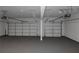 Clean two car garage showcasing an epoxy floor and white doors at 420 Tavistock Ct, Mcdonough, GA 30252