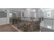 Hallway with a staircase and wrought iron railings at 420 Tavistock Ct, Mcdonough, GA 30252
