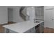 Kitchen island with stainless steel appliances and a view of the staircase at 420 Tavistock Ct, Mcdonough, GA 30252