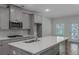 Modern kitchen with stainless steel appliances, herringbone backsplash, and a large center island at 420 Tavistock Ct, Mcdonough, GA 30252