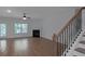 Open concept living room featuring fireplace, light wood flooring, and access to the backyard at 420 Tavistock Ct, Mcdonough, GA 30252