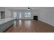 Spacious living room with modern fireplace, light wood floors, open kitchen, and outdoor access at 420 Tavistock Ct, Mcdonough, GA 30252
