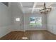 Bright living room features stylish coffered ceilings, modern lighting, and elegant wainscoting at 420 Tavistock Ct, Mcdonough, GA 30252