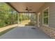 Covered patio with ceiling fan overlooks large backyard and beautiful forest views at 420 Tavistock Ct, Mcdonough, GA 30252