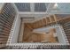 Unique bird's-eye view of staircase with wood steps, wrought iron railings, and light wood floors at 420 Tavistock Ct, Mcdonough, GA 30252