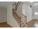 Elegant foyer with a staircase featuring wood and wrought iron, plus detailed wainscoting at 420 Tavistock Ct, Mcdonough, GA 30252