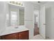 Bathroom featuring a vanity with sink, large mirror and a doorway to the bedroom at 3656 Oak Sw Ln, Powder Springs, GA 30127