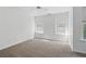 Cozy bedroom showcasing neutral walls, plush carpet, and large windows for plenty of natural light at 3656 Oak Sw Ln, Powder Springs, GA 30127