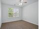 Bright bedroom with neutral carpet and natural light from a large window at 3656 Oak Sw Ln, Powder Springs, GA 30127