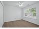 Bright bedroom with neutral carpet, ceiling fan, and natural light from a large window at 3656 Oak Sw Ln, Powder Springs, GA 30127