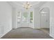 Formal dining room with a chandelier, bay window, and wainscoting at 3656 Oak Sw Ln, Powder Springs, GA 30127