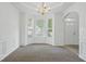 Dining room with carpet, white walls and trim, a bay window and a chandelier at 3656 Oak Sw Ln, Powder Springs, GA 30127