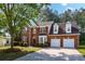 Charming two-story brick home with well-manicured lawn and a two car garage at 3656 Oak Sw Ln, Powder Springs, GA 30127