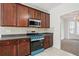 This traditional-style kitchen features stainless steel appliances, cherry cabinets, and a bright breakfast area at 3656 Oak Sw Ln, Powder Springs, GA 30127