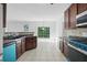 The kitchen and eating area has stainless appliances, tiled floors and a large sliding door to the back yard at 3656 Oak Sw Ln, Powder Springs, GA 30127