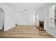 Open living room with wood floors, a brick fireplace, and white trim at 3656 Oak Sw Ln, Powder Springs, GA 30127