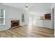 Open-concept living room with brick fireplace and views of the kitchen at 3656 Oak Sw Ln, Powder Springs, GA 30127