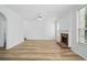Spacious living room featuring a brick fireplace and new flooring at 3656 Oak Sw Ln, Powder Springs, GA 30127