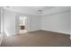Large primary bedroom with plush carpet, ceiling fan, and en-suite bathroom at 3656 Oak Sw Ln, Powder Springs, GA 30127