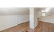 Attic space with wood laminate flooring, bright light and white brick pillar at 1560 Temple Ave, College Park, GA 30337