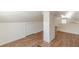Bright attic space features wood flooring and a painted brick column at 1560 Temple Ave, College Park, GA 30337