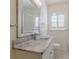 Bathroom featuring marble countertop, and a window with plantation shutters at 1560 Temple Ave, College Park, GA 30337
