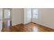 Spacious bedroom featuring hardwood floors, a built in wardrobe, and bright natural light at 1560 Temple Ave, College Park, GA 30337