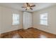 Cozy bedroom with hardwood floors, ceiling fan, and built-in closet at 1560 Temple Ave, College Park, GA 30337