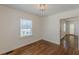 Well-lit bedroom with hardwood floors and a view of the front yard at 1560 Temple Ave, College Park, GA 30337