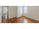 Bedroom with hardwood floors, closet and a window allowing natural light at 1560 Temple Ave, College Park, GA 30337