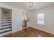 Bright dining area with hardwood floors, stairs nearby, and ample natural light at 1560 Temple Ave, College Park, GA 30337