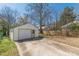 Detached one-car garage with a single-car garage door, side entry door, and concrete driveway at 1560 Temple Ave, College Park, GA 30337