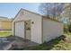 Detached one-car garage with a single-car garage door, side entry door, and concrete driveway at 1560 Temple Ave, College Park, GA 30337