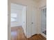 Hallway view featuring hardwood floors, a bedroom entrance, and a glass paneled door at 1560 Temple Ave, College Park, GA 30337