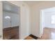 Hallway view featuring hardwood floors, a paneled front door and and bedroom access at 1560 Temple Ave, College Park, GA 30337
