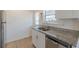 Kitchen area features granite countertops, stainless steel appliances, and white cabinets at 1560 Temple Ave, College Park, GA 30337