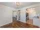 Open-concept living space with hardwood floors and views of the staircase and kitchen at 1560 Temple Ave, College Park, GA 30337
