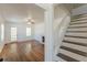 Inviting living room with hardwood floors, fireplace, and staircase leading to the second floor at 1560 Temple Ave, College Park, GA 30337