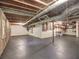 Spacious unfinished basement with exposed ceiling, concrete flooring, and natural light from a window at 351 Ridgewater Dr, Marietta, GA 30068