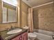 Cozy bathroom with a shower/tub combo, granite sink, and decorative mirror at 351 Ridgewater Dr, Marietta, GA 30068