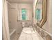 Bright bathroom features tiled shower and tub, patterned wallpaper, and tiled counter space at 351 Ridgewater Dr, Marietta, GA 30068