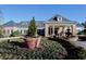 Stately clubhouse featuring brick accents, a covered entrance, and a beautifully landscaped fountain area at 351 Ridgewater Dr, Marietta, GA 30068