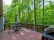 Outdoor deck with dining set overlooking a beautiful wooded area, great for entertaining and relaxation at 351 Ridgewater Dr, Marietta, GA 30068