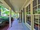Covered front porch with a seating area, offering a relaxing space with views of the landscaped yard at 351 Ridgewater Dr, Marietta, GA 30068