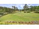 Scenic view of the golf course with lush green grass and a tranquil pond at 351 Ridgewater Dr, Marietta, GA 30068