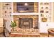 Charming living room featuring a brick fireplace with a TV above and built-in bookshelves at 351 Ridgewater Dr, Marietta, GA 30068