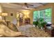 Bright living room with hardwood floors, a ceiling fan, and a sliding glass door leading to a deck at 351 Ridgewater Dr, Marietta, GA 30068