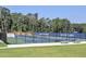 The fenced tennis courts, part of Walton High School's athletic facilities, surrounded by lush green trees and grass at 351 Ridgewater Dr, Marietta, GA 30068